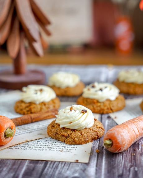 Grain-Free Carrot Cake Pumpkin Crumbl-style cookies with cream cheese icing and cookie crumbs on top.