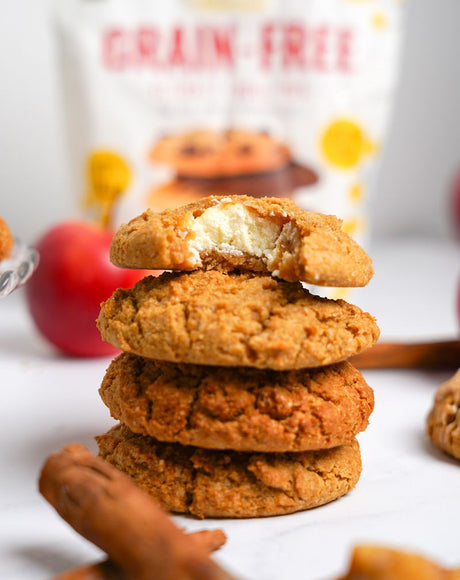 Cassava Flour pumpkin cookie stuffed with cheesecake filling. Bag of Otto's Naturals Grain-Free Ultimate Cookie Mix in background