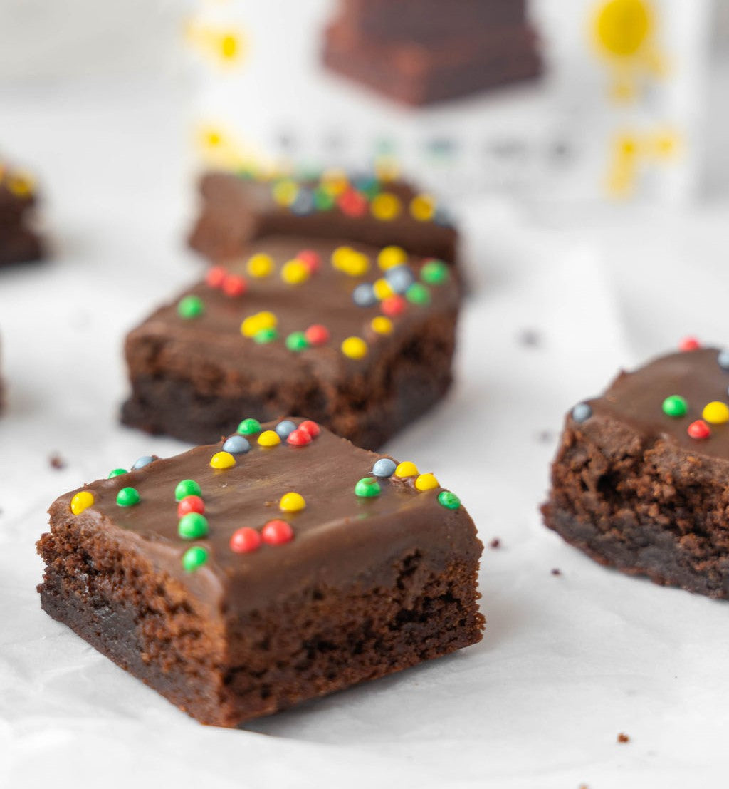 Grain-Free cosmic brownies (brownies covered in ganache and colorful round sprinkles)