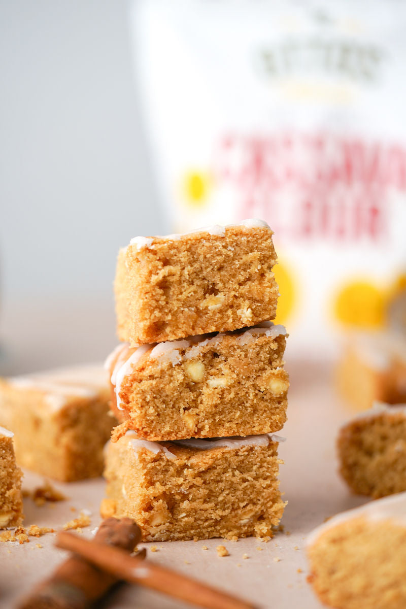 3 stacked grain-free white chocolate chai blondies. Bag of Otto's Naturals Cassava Flour in background