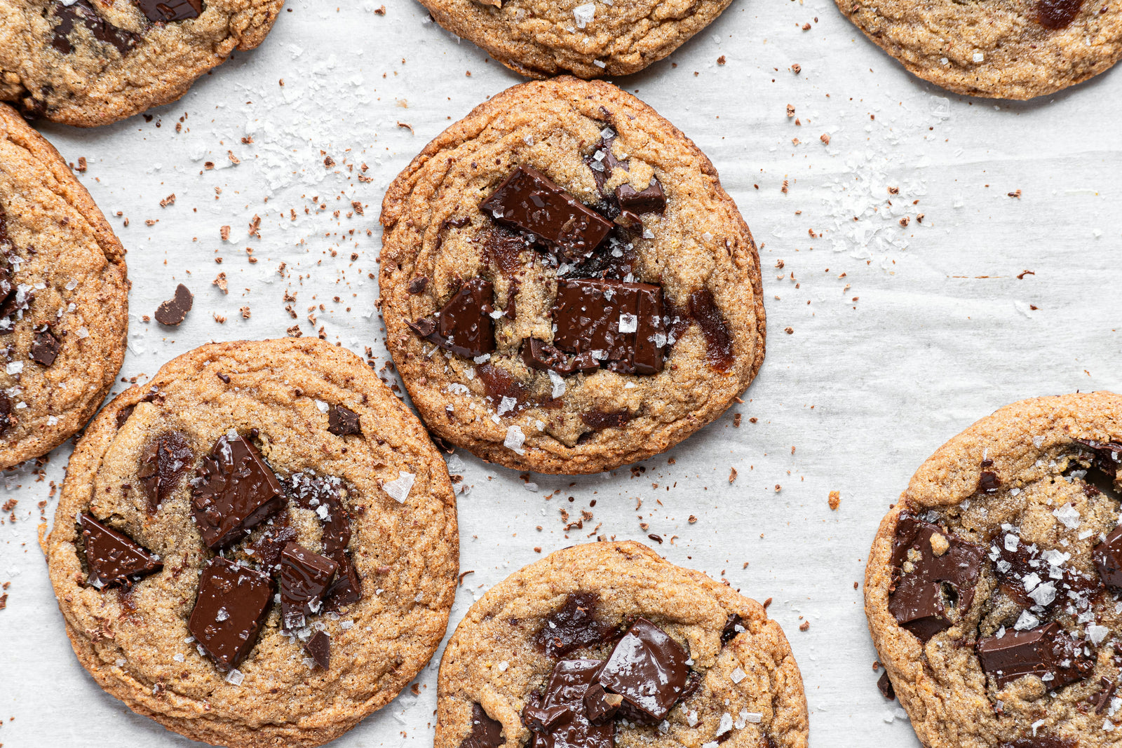 grain-free apple butter chocolate chunk cookies laying flat with flaky salt on top